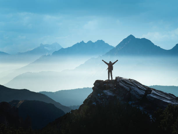 person standing on mountain top