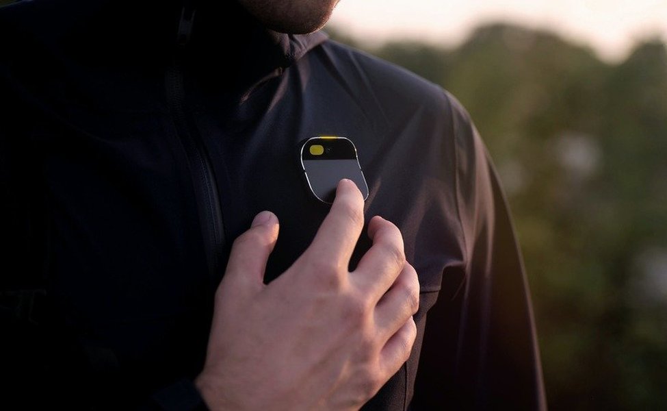 A person interacting with a futuristic AI assistant device
