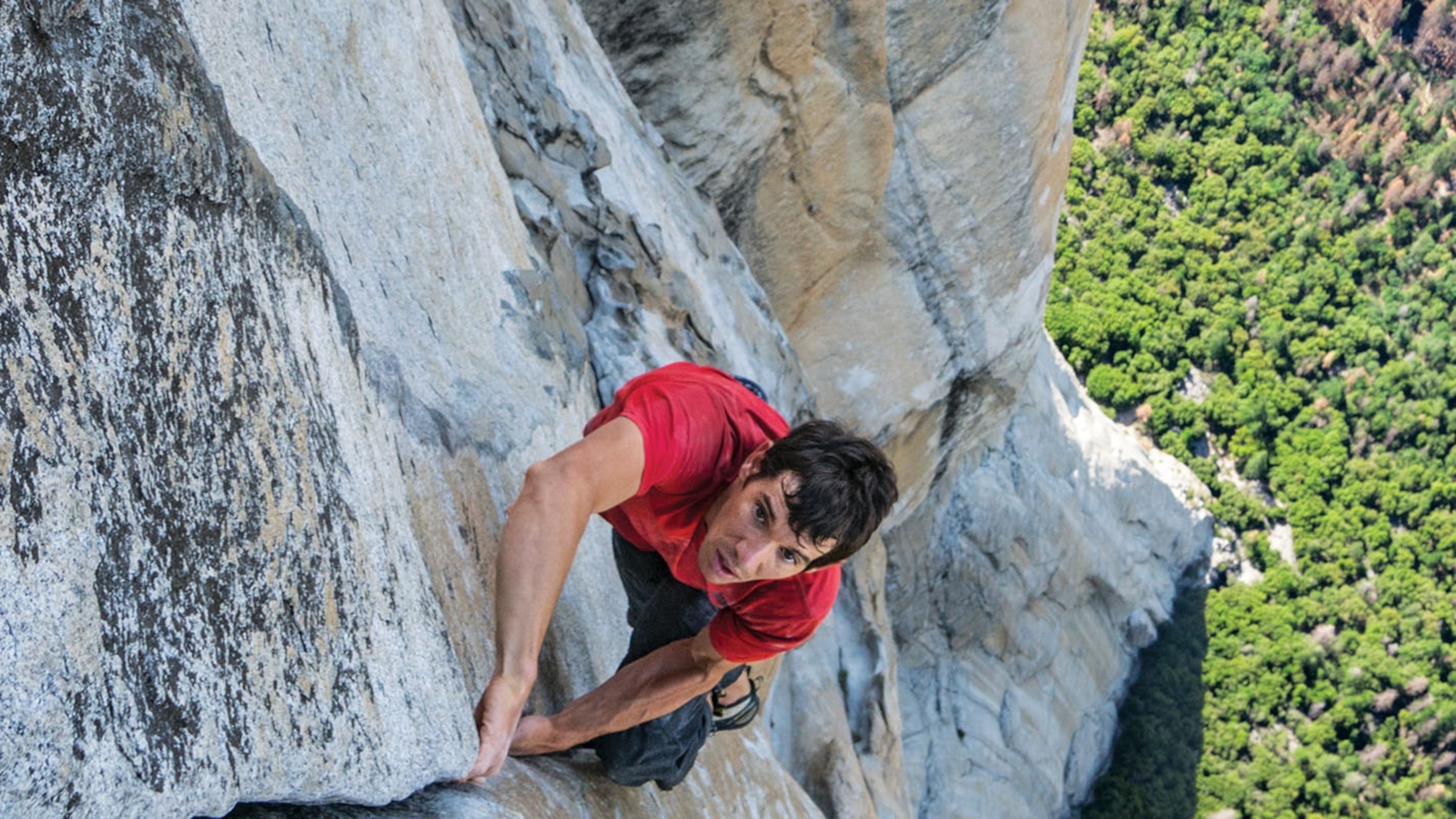 focused person climbing mountain