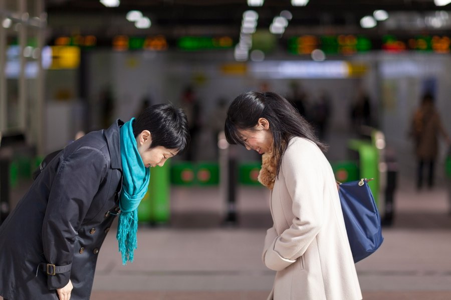 People bowing as a form of greeting in Japan.