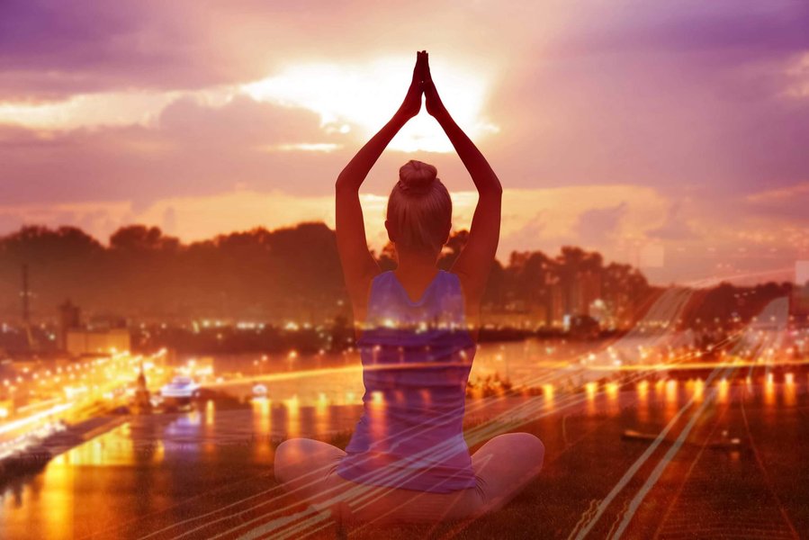 Woman practicing yoga outdoors, embodying grace and connection with nature.