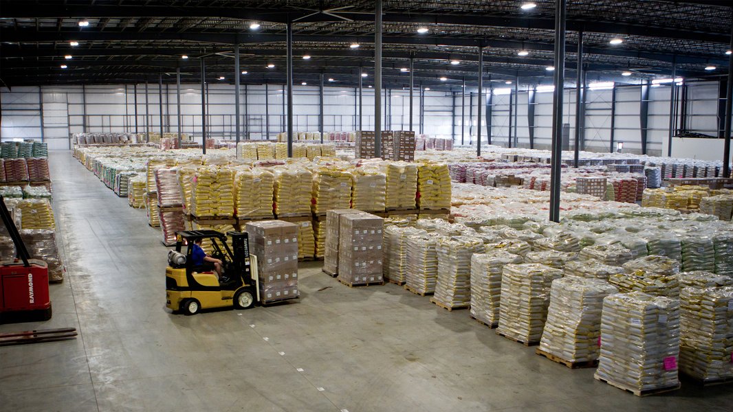 Interior of a large, modern warehouse with stacked goods