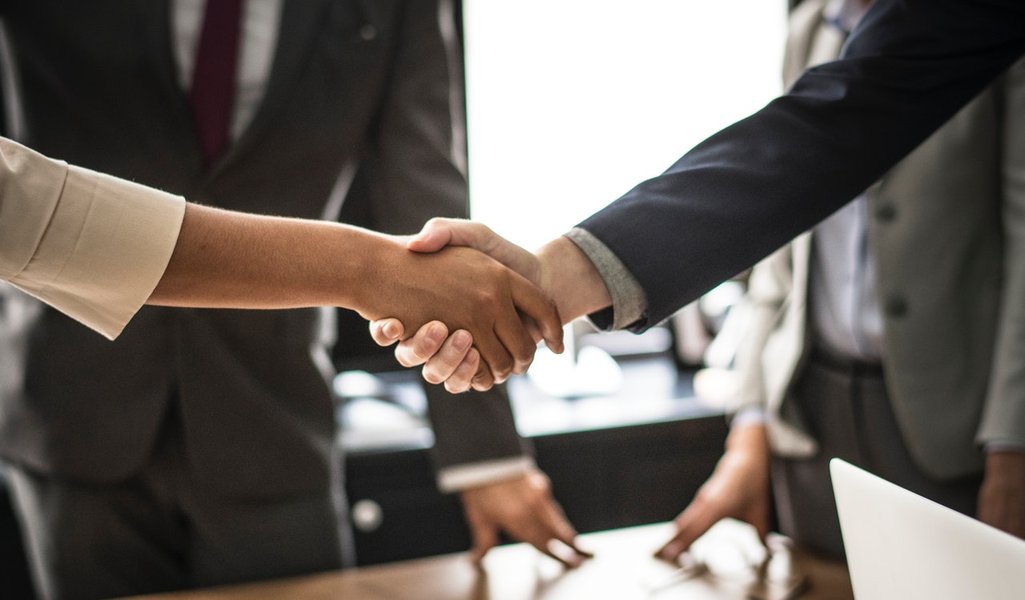 Two people shaking hands in a professional setting
