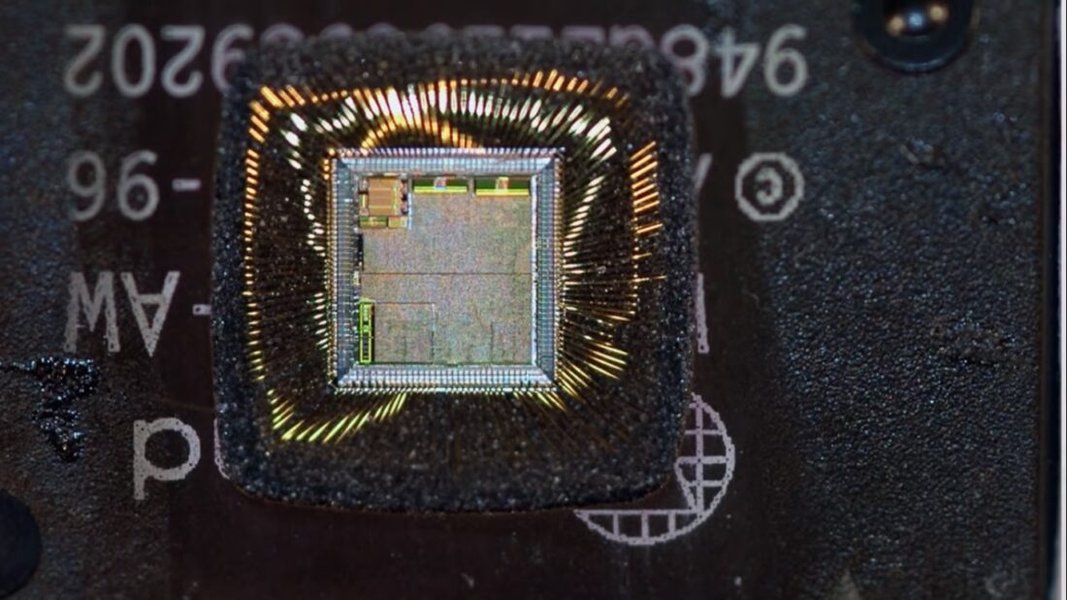 computer microchip circuit board with magnifying glass