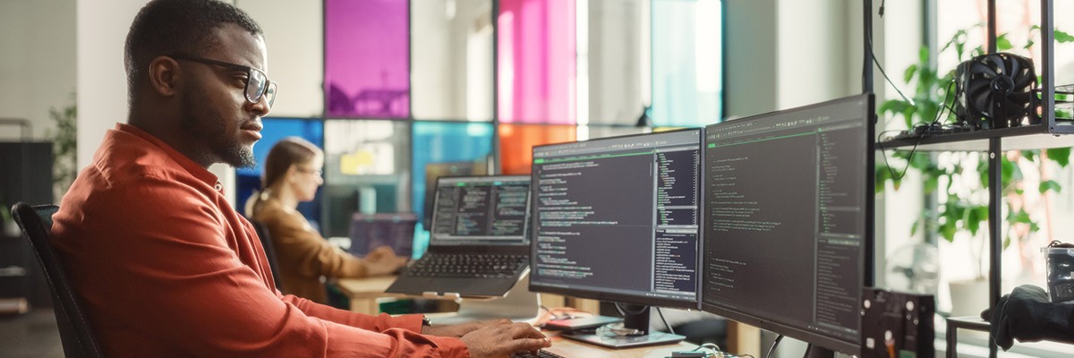 tech developers workspace with screens showing code