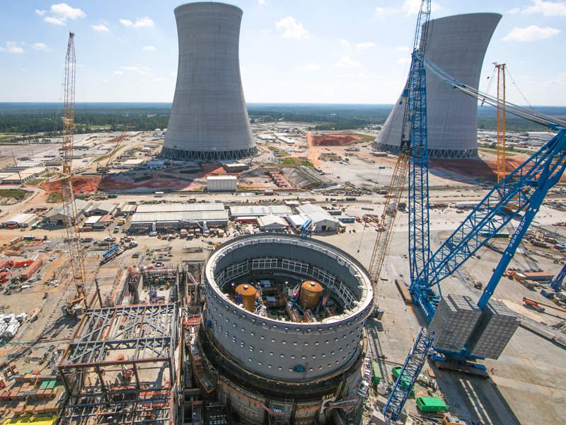 Aerial view of the Vogtle Electric Generating Plant, showcasing its immense scale with multiple reactor units.