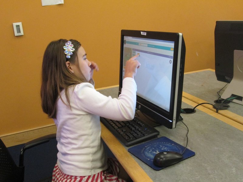 Students using visual programming in a classroom