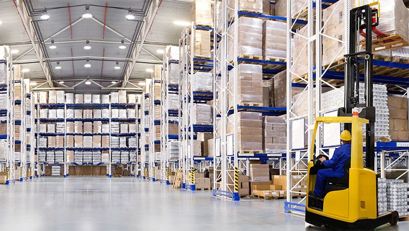 modern warehouse interior with stacked boxes and machinery