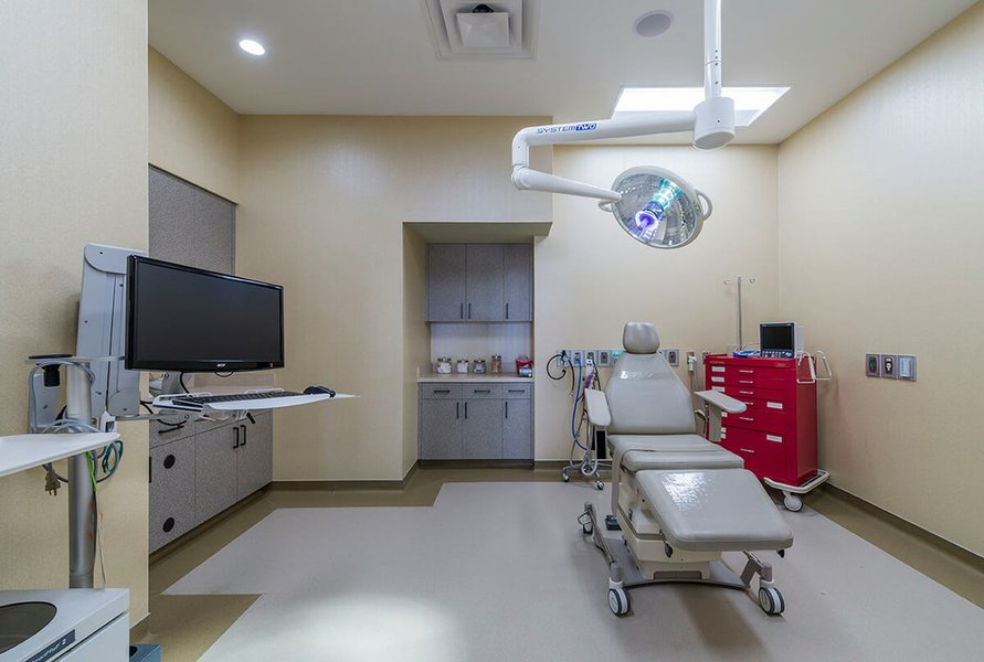Dental professional performing reconstructive oral surgery