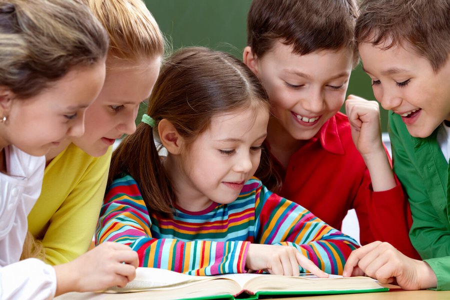 Children engaged in a book reading session