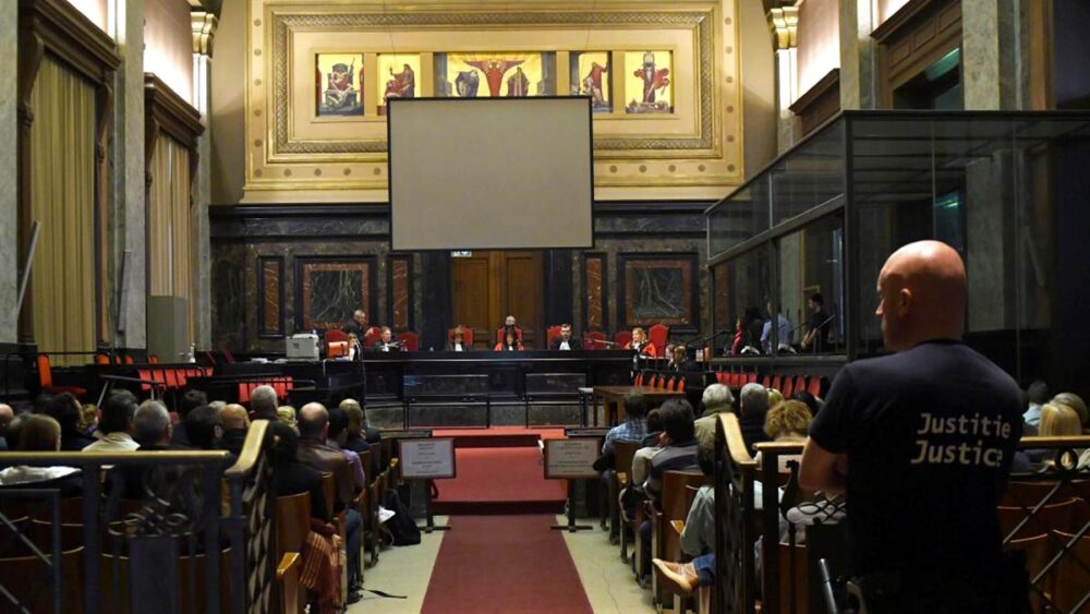 Belgian political meeting, legal documents, courtroom