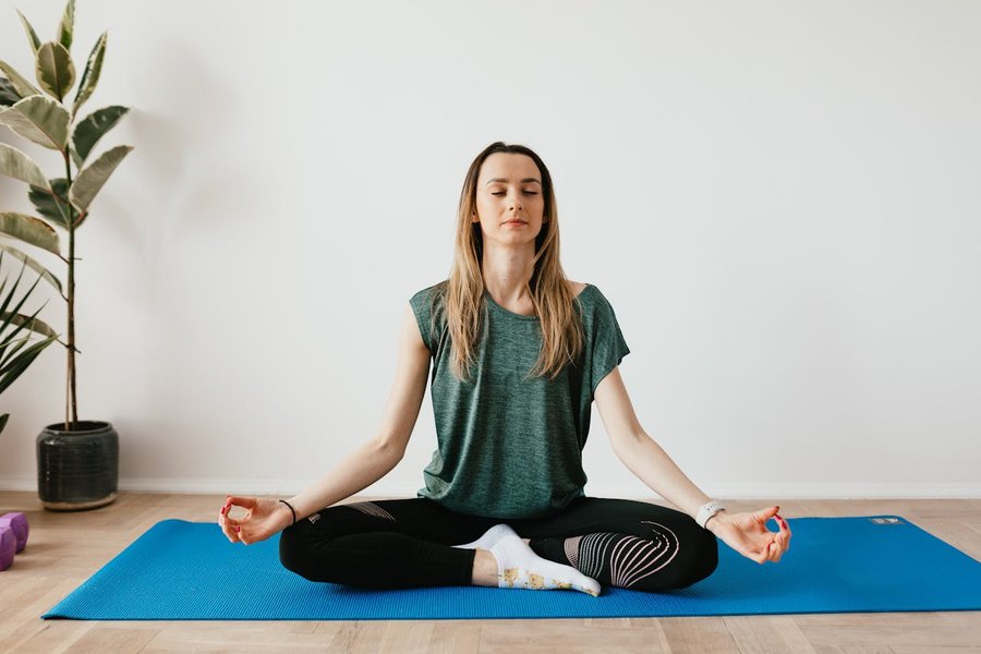 A person practicing yoga in a serene home environment.