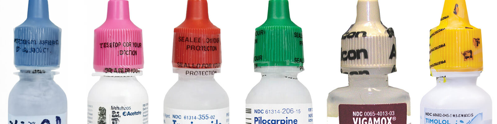 medication bottles with eye drops and glasses on table