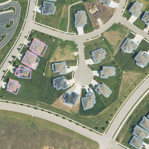 An image showing multiple building footprint datasets overlaid on aerial imagery