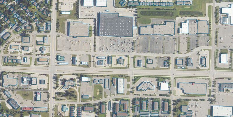 Aerial imagery of an urban block with buildings identified using detailed blue outlines