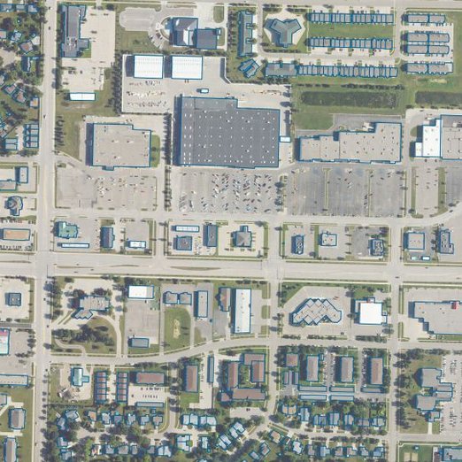 Aerial imagery of an urban block with buildings identified using detailed blue outlines