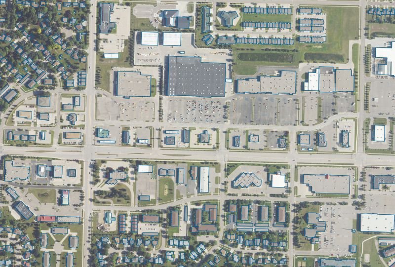 Aerial imagery of an urban block with buildings identified using detailed blue outlines