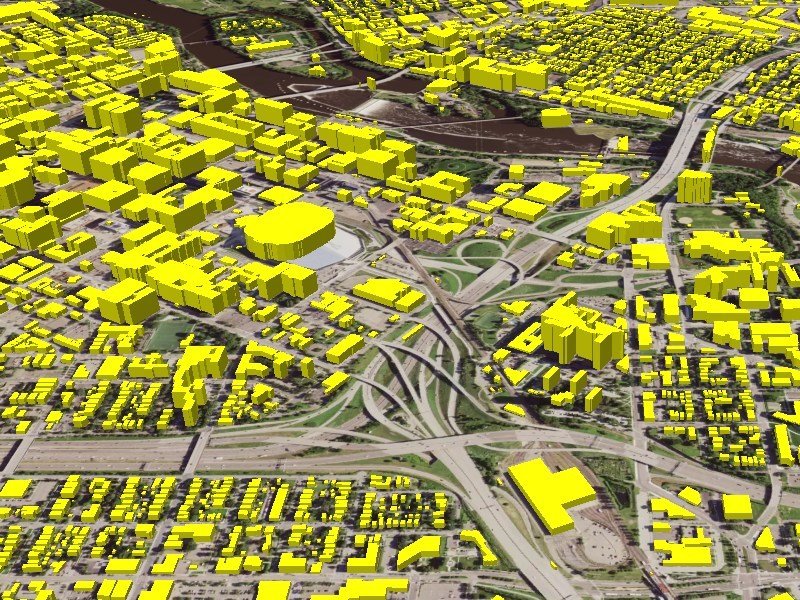 A 3D oblique GIS map showing a city landscape with all building footprints extruded into solid, bright-yellow block models. The yellow structures represent varying building heights and shapes.