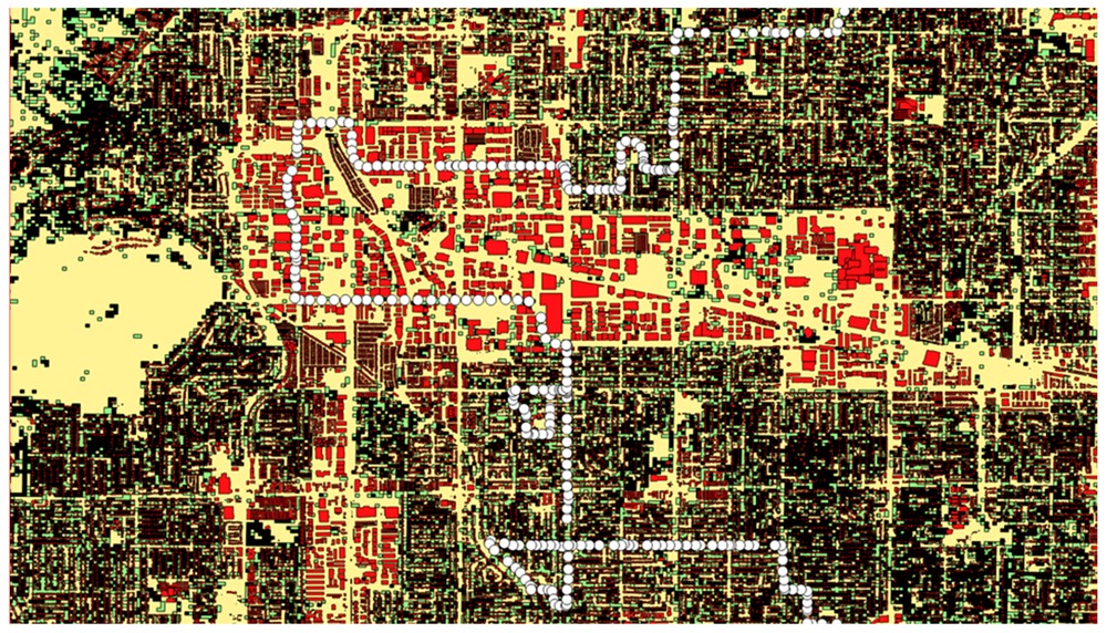 This is a pixelated, color-coded urban map filled with red, beige, green, and black blocks. A prominent white dotted line winds across the grid, tracing a specific route through the city.
