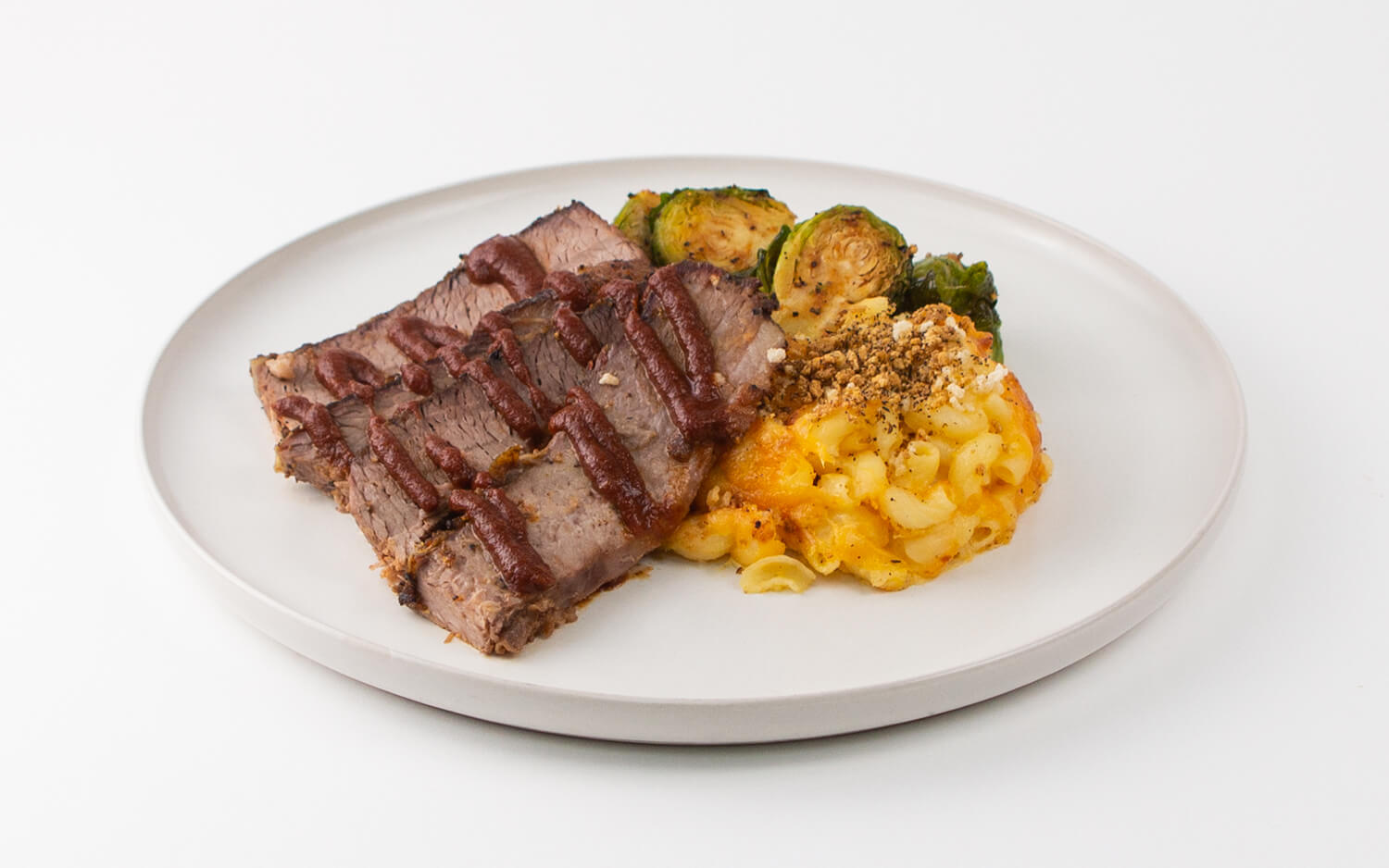 Slow-cooked BBQ Brisket with Southern Style Cheddar Mac and Cheese with roasted Brussels sprouts. 