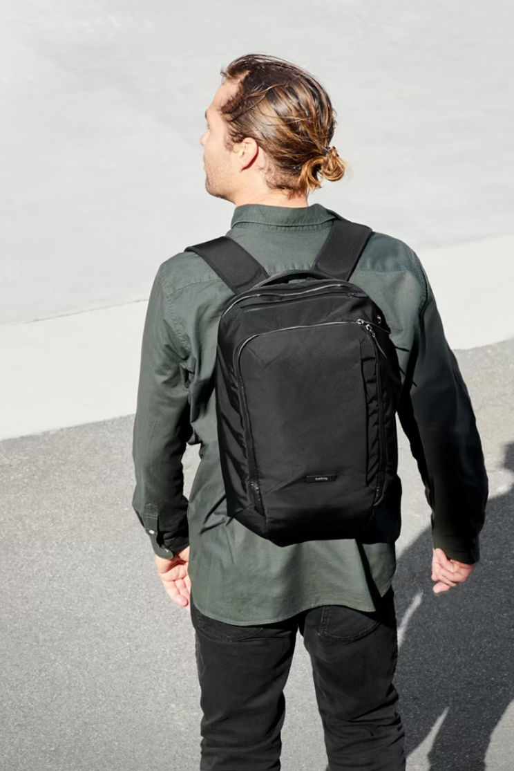 a person models a black bellroy tranit workplace backpack