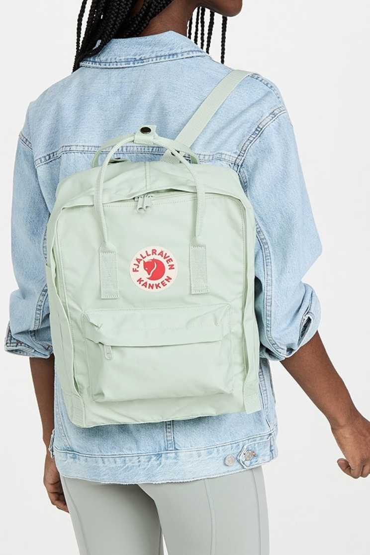a person models a pale blue kanken backpack