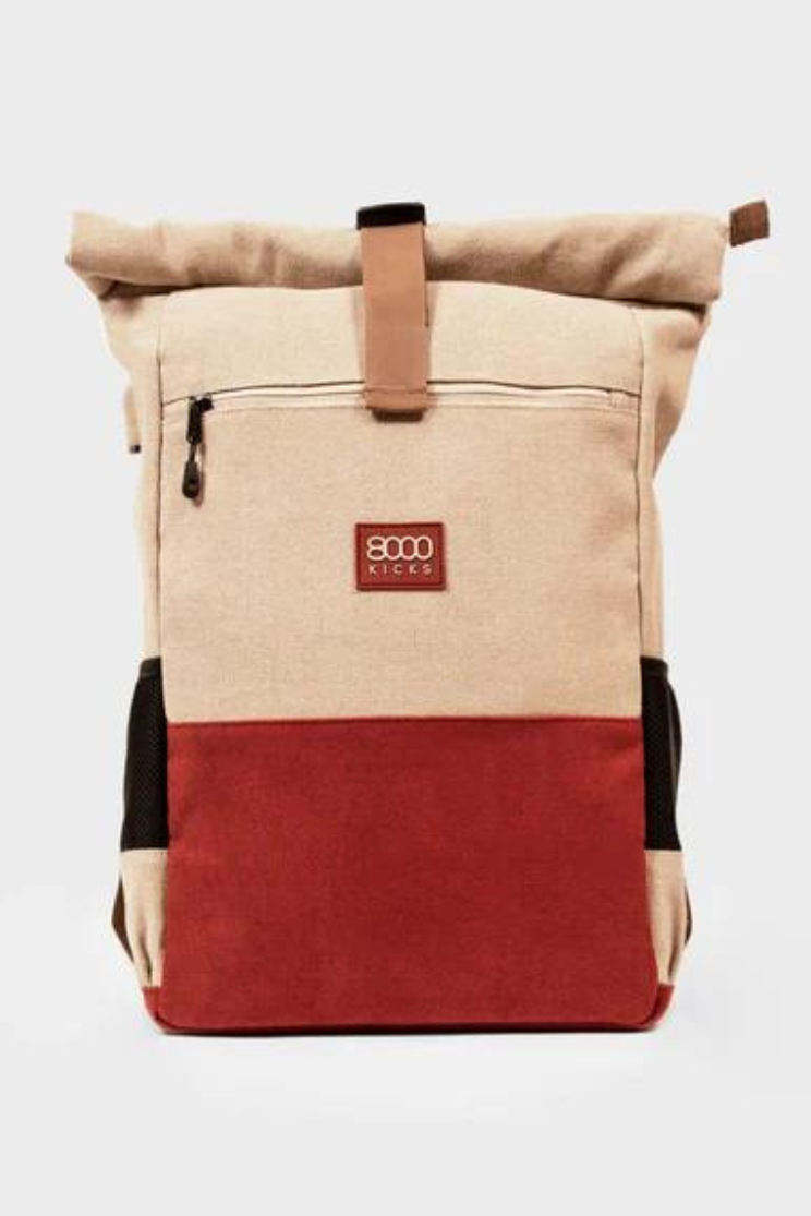 a hemp backpack that is beige on the upper portion and red on the lower. it has a zipper on the upper above a 8000 kicks logo.