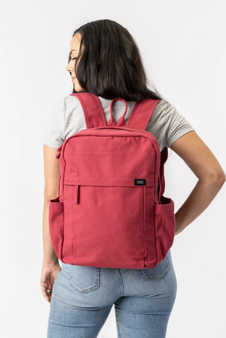 a person models the red version of the bag in the first image.