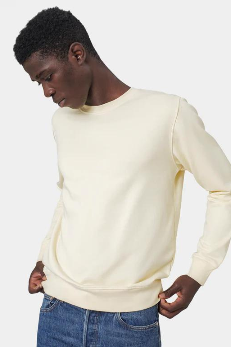a man models a long sleeve white crew tee with jeans