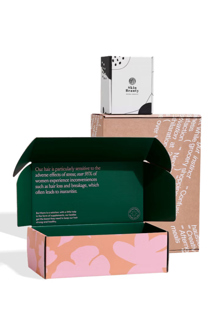 a custom mailer box with two-tone pink exterior and a deep green interior that says "our hair is particularly sensitive to the adverse effects of stress, over 95% of women experience inconviences such as hair loss and breakage, which often leads to insecurities."