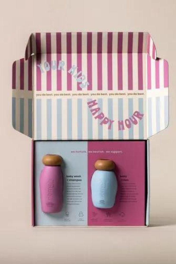 a custom insert box with the interior top decorated with pink and white stripes on top, and blue and white on the bottom. the words "your kids happy hour" in a squiggle across the stripes.