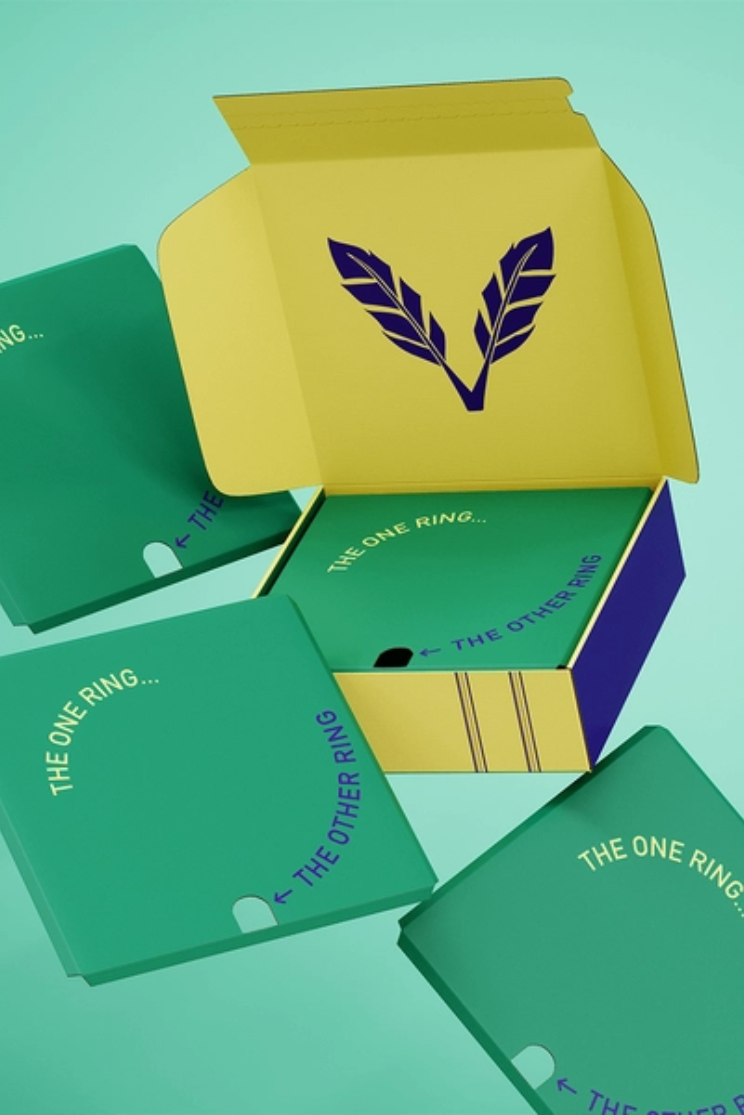 a custom box in yellow, blue, and green with a logo of two feathers and the words "the one ring...the other ring"