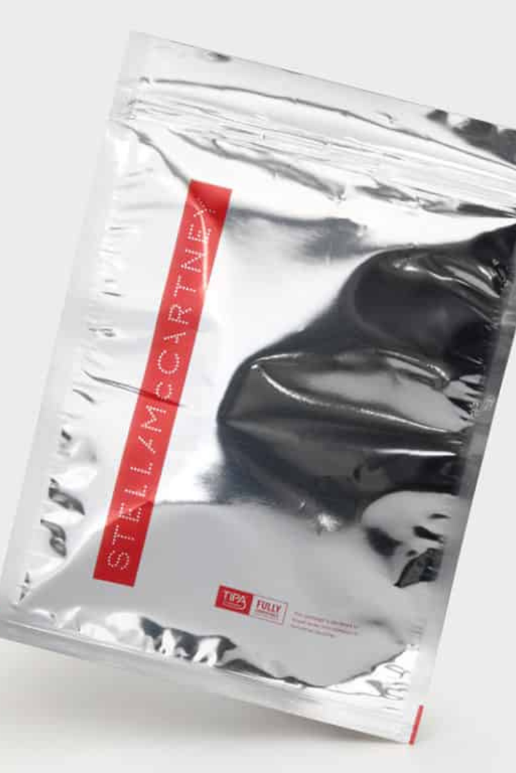 a silver resealable mailer with the brand "stella mcCartney" written in silver against a red background