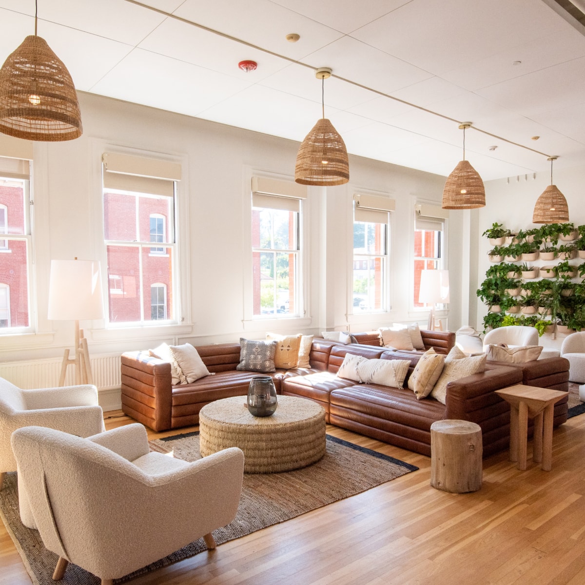 An empty, nicely decorated lounge area with large comfortable-looking couches