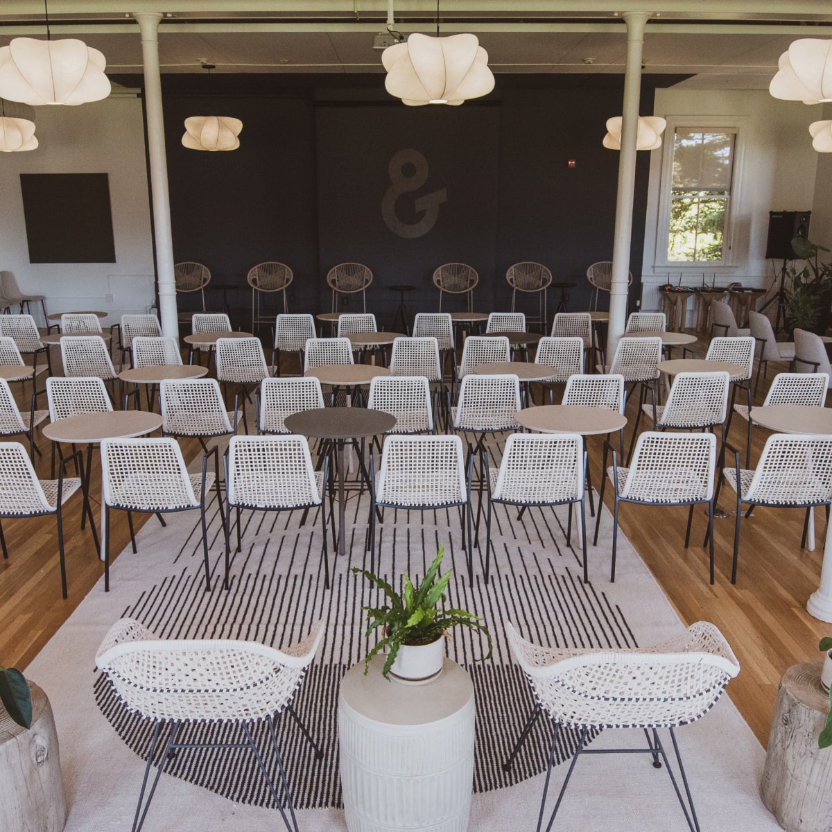 A stage with empty chairs facing it 