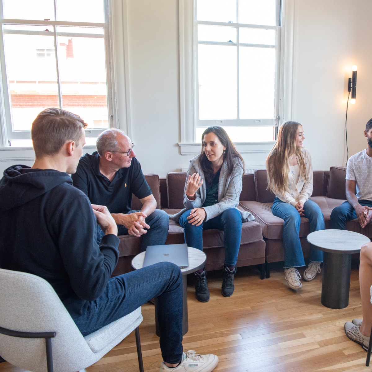 People chatting while sitting on a large couch