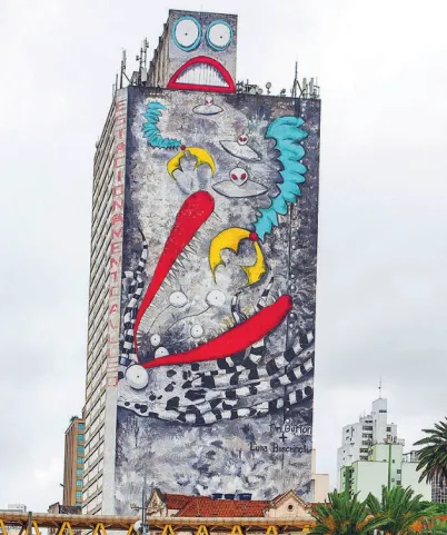 Imagem de mural grafitado na parede externa de um prédio. O mural representa um robô com duas garras e discos voadores.