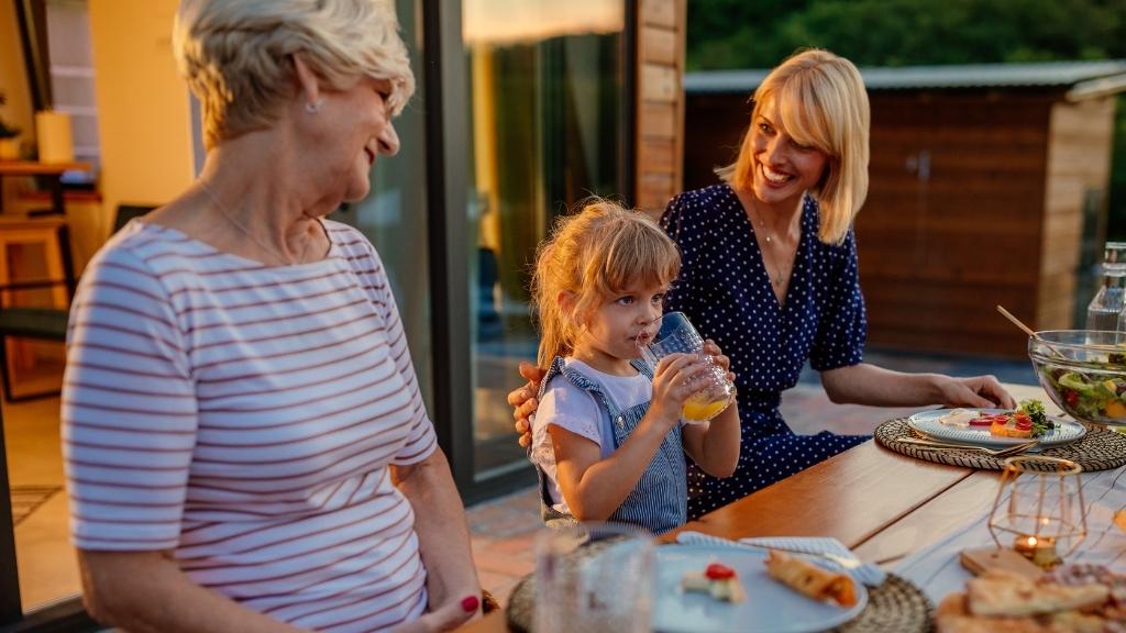 Grandmother having dinner with her daughter and grand-daughter