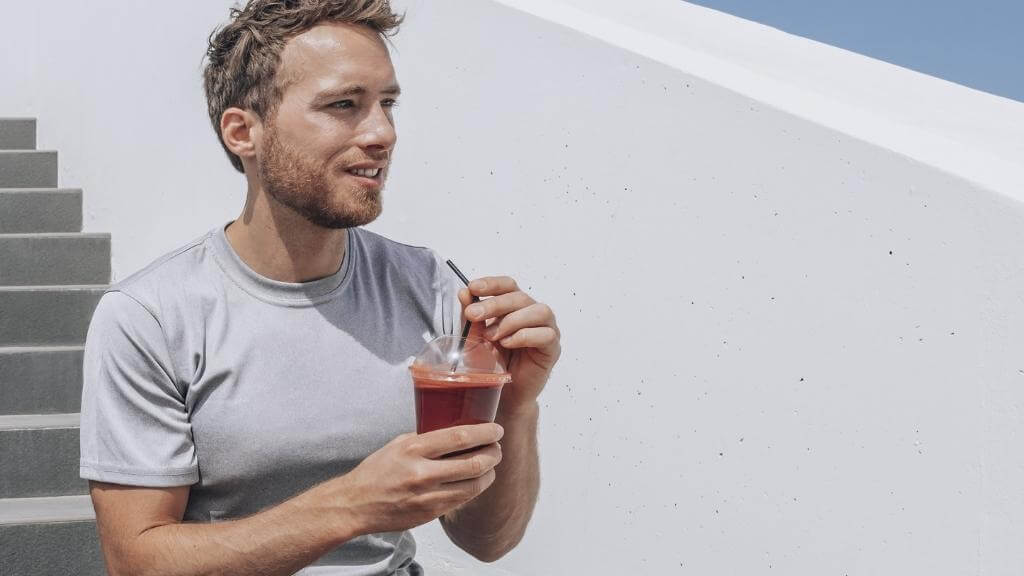 Athletic man enjoying a beet smoothie