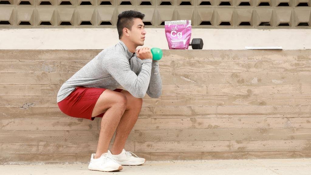 Young man working out outside with an Essential elements Collagen Peptides bag in the background