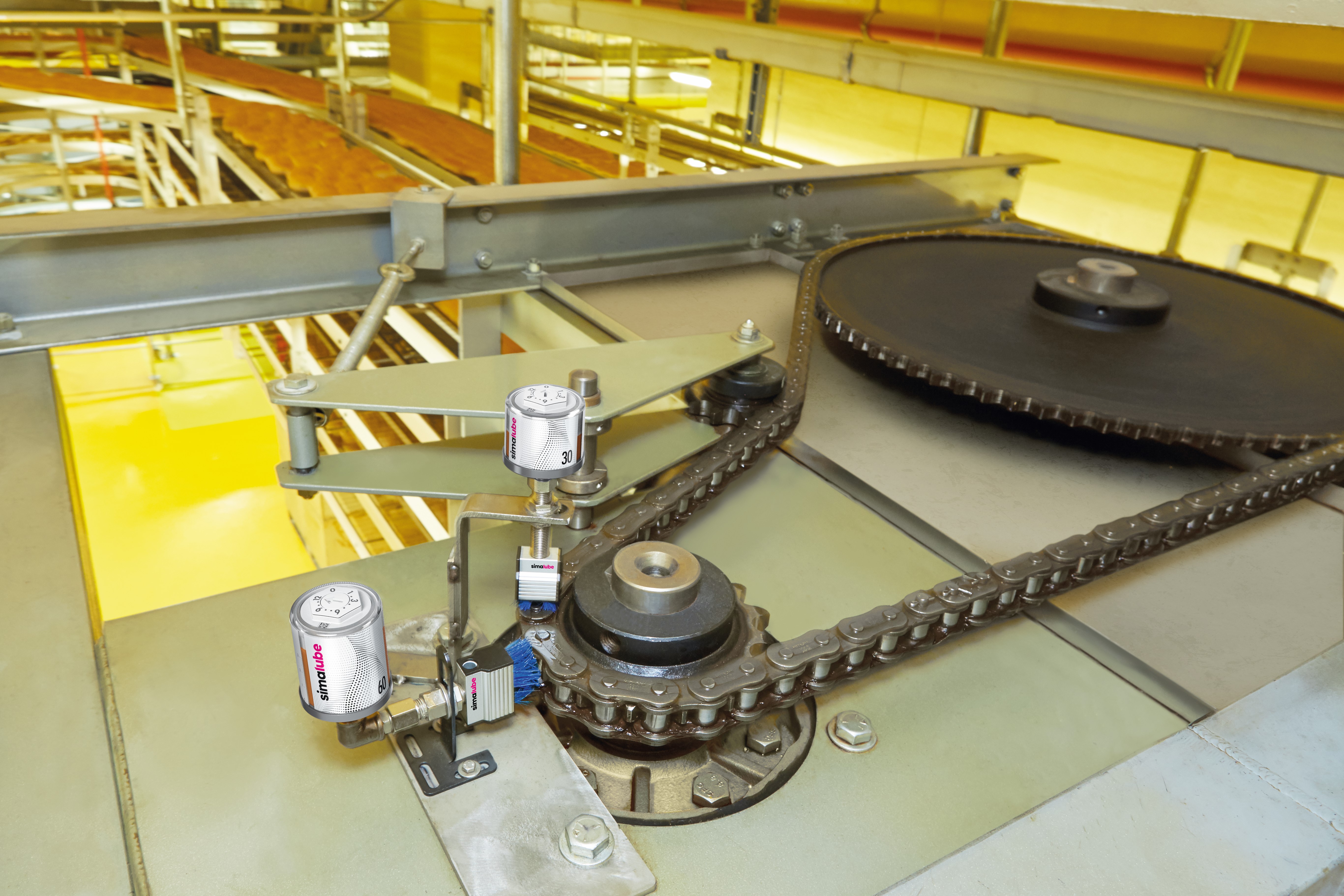 simalube attached with brush to lubricate and clean the conveyor belts and chains while lubricating it.