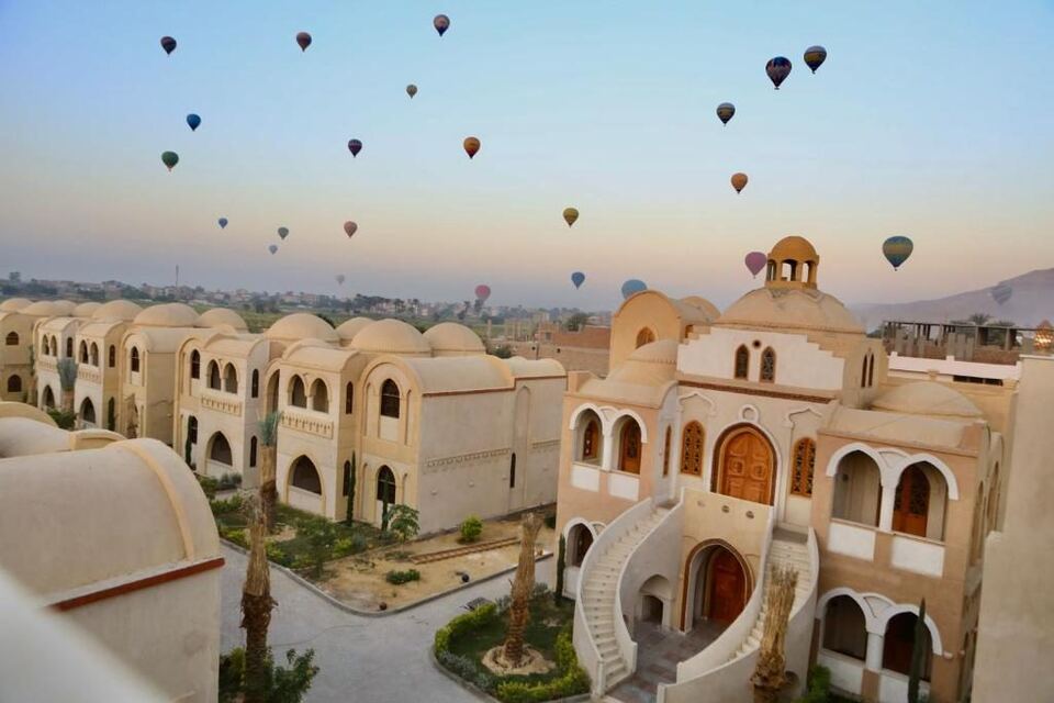 Balloons over the Omda domes at sunrise