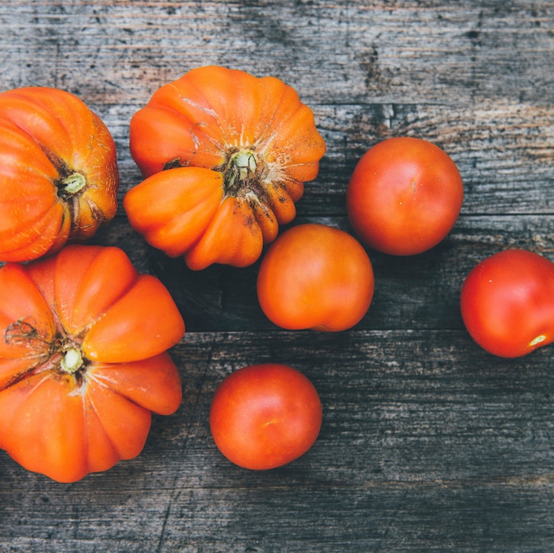 overhead view of heirloom tomatoes on wood table