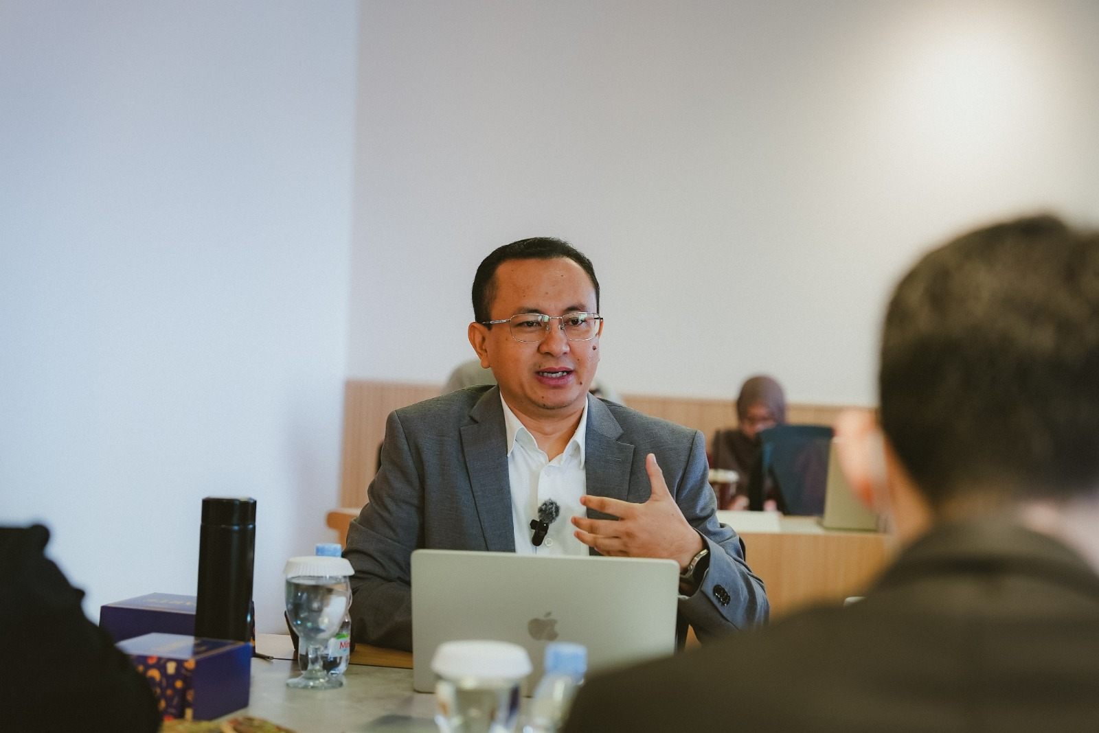 a man speaking to a group of people