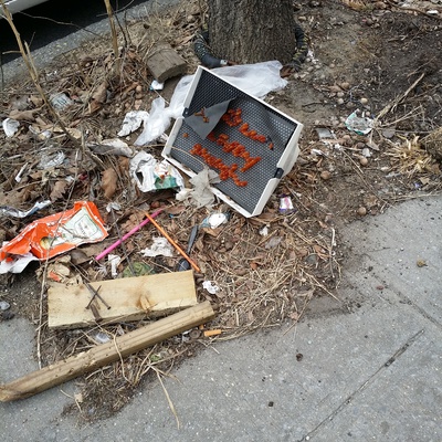 Leftover trash near tree on N 10th