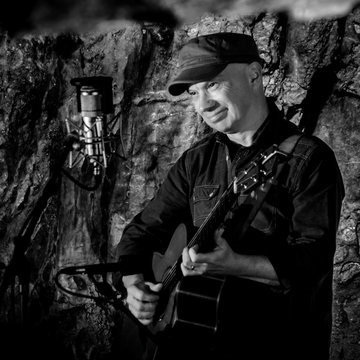 Hire Andy J Rogers Singing guitarist with Encore