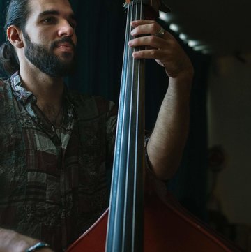 Hire Dionisio Perez-Mavrogenis Bass guitarist with Encore