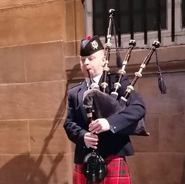 Hire Mark Black Bagpiper with Encore