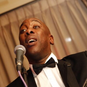 Hire Kojo Singing guitarist with Encore