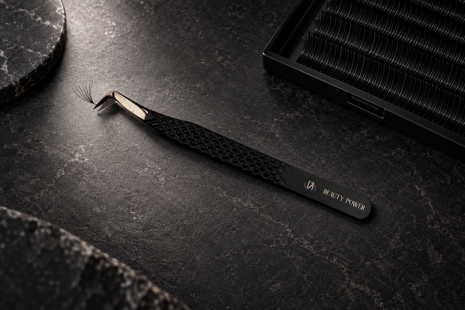 Boot volume tweezers gripping a lash fan base